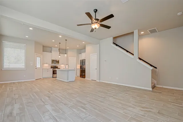 a view of a kitchen with a sink and a window