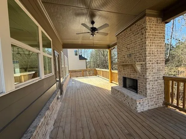 a view of a livingroom with wooden floor and a ceiling fan