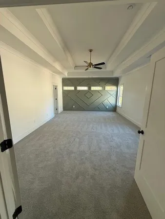 a view of an empty room and chandelier