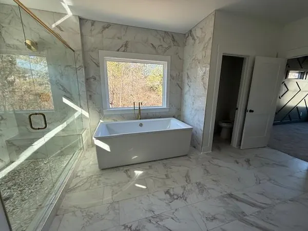 a spacious bathroom with a large tub and shower