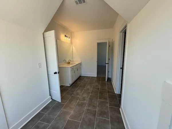 a bathroom with a sink and mirror