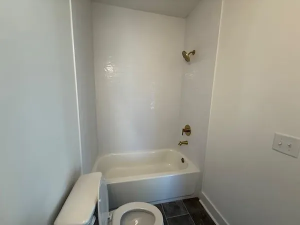 a white bath tub sitting next to a white toilet