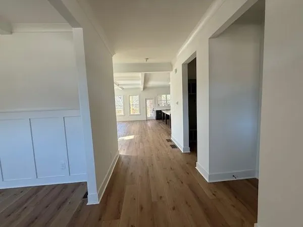 a view of a hallway with wooden floor