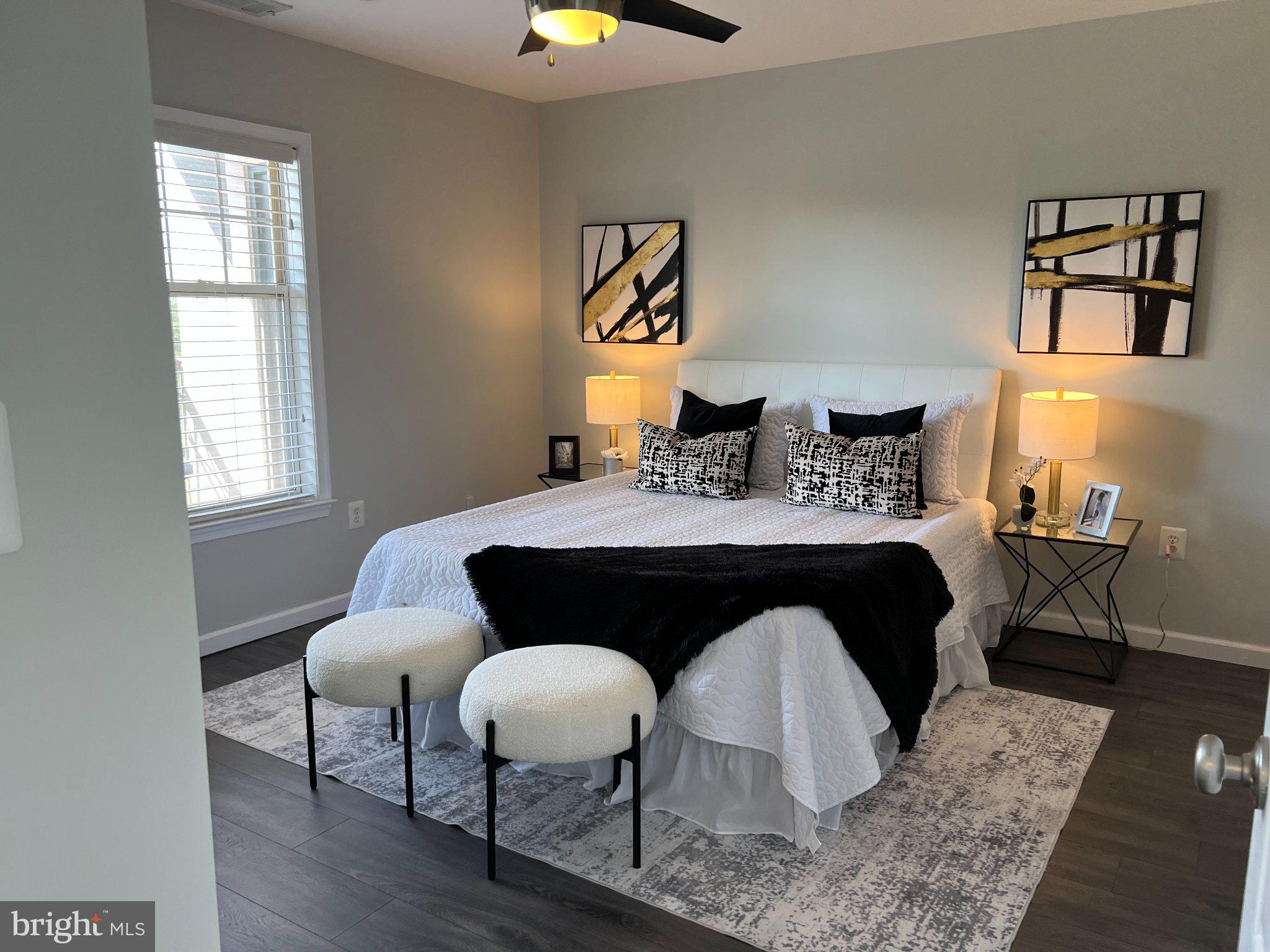 Large primary bedroom with ceiling fan.