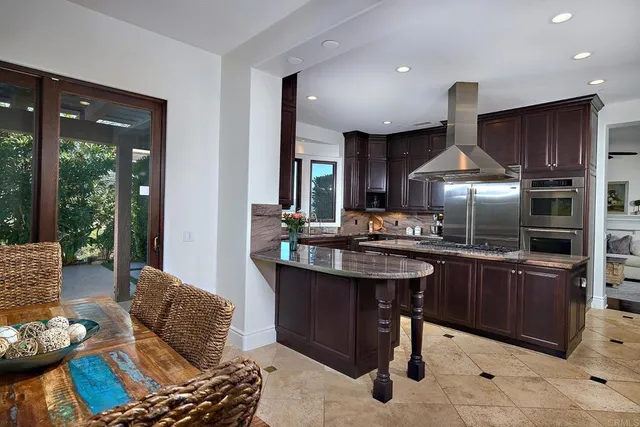 a spacious bathroom with a sink a granite counter and a large mirror