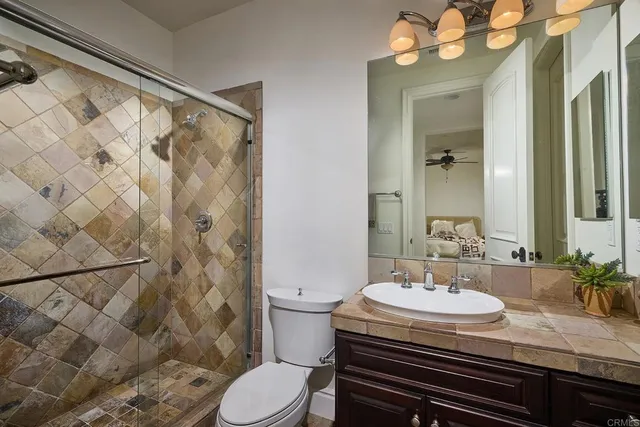 a bedroom with a bed and a potted plant