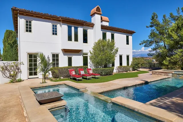 a view of a patio with a table under an umbrella
