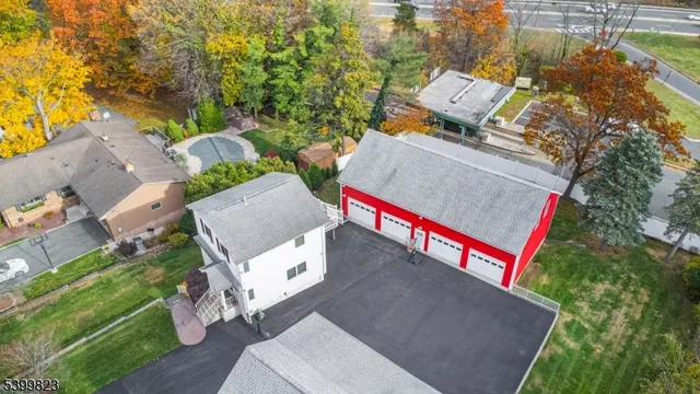 an aerial view of a house with swimming pool and outdoor space