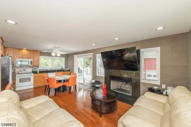a living room with fireplace furniture and a large window