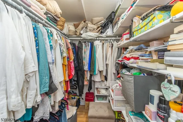 a bedroom with a bed and a flat tv screen on dresser