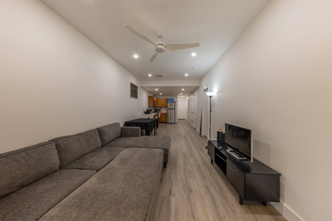 2824 Rio Grande Street, Unit 101 Austin, TX 78705 - Photo 6 of 10 a living room with furniture and a flat screen tv