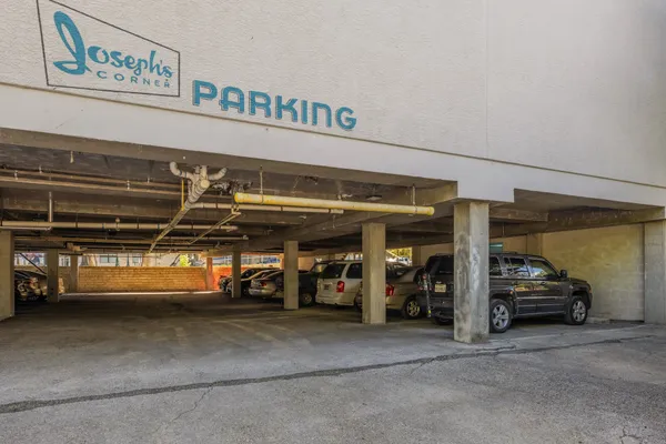 a view of parking garage with cars