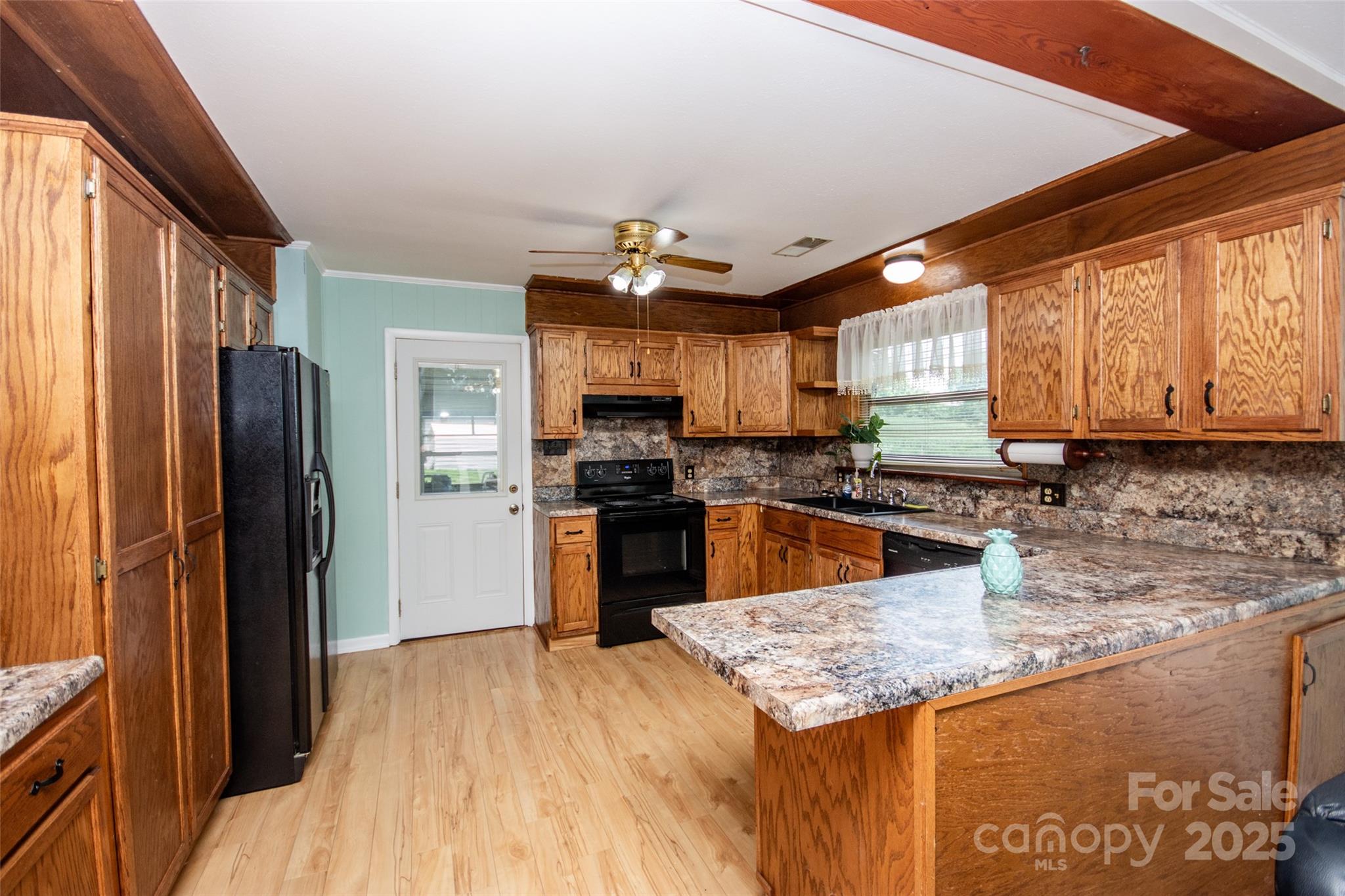 615 Bell Farm Road Statesville, NC 28625 - Photo 18 of 46 a kitchen with stainless steel appliances granite countertop a refrigerator a sink dishwasher a stove with wooden cabinets and floor