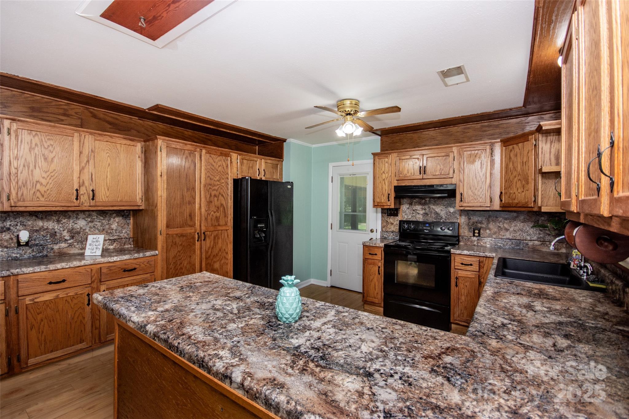 615 Bell Farm Road Statesville, NC 28625 - Photo 19 of 46 a kitchen with stainless steel appliances granite countertop a sink stove and refrigerator