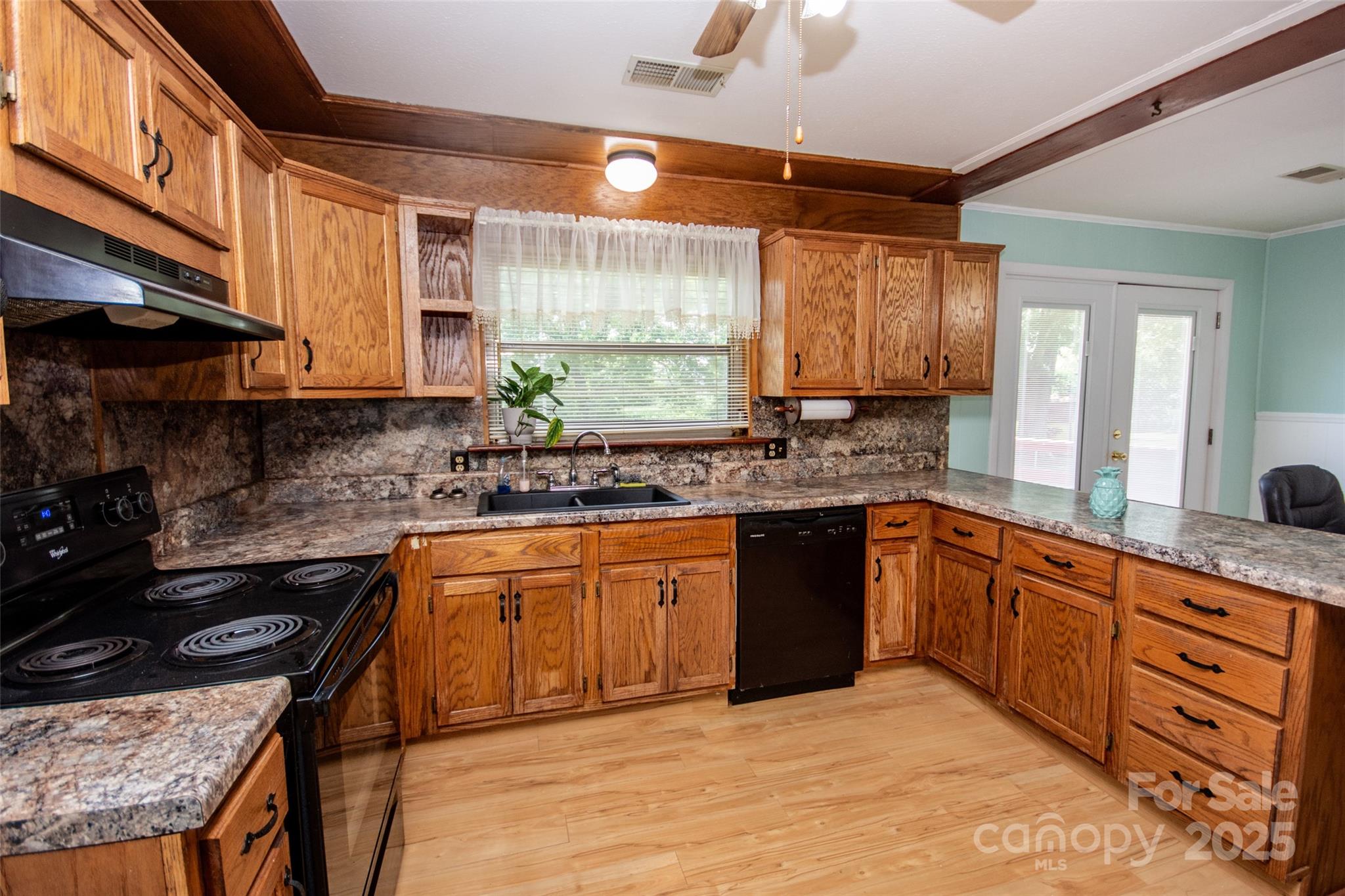 615 Bell Farm Road Statesville, NC 28625 - Photo 20 of 46 a kitchen with stainless steel appliances granite countertop wooden cabinets a stove a sink and a microwave