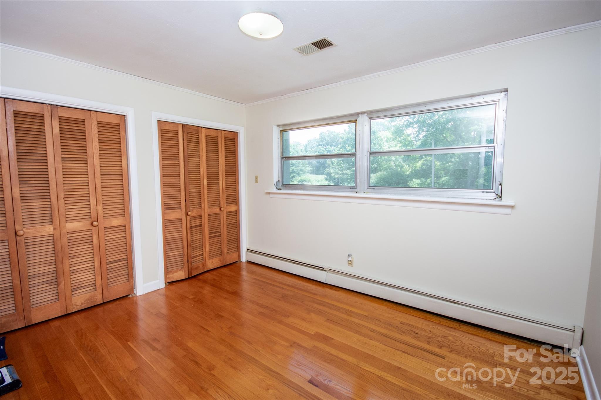 615 Bell Farm Road Statesville, NC 28625 - Photo 23 of 46 an empty room with wooden floor and windows