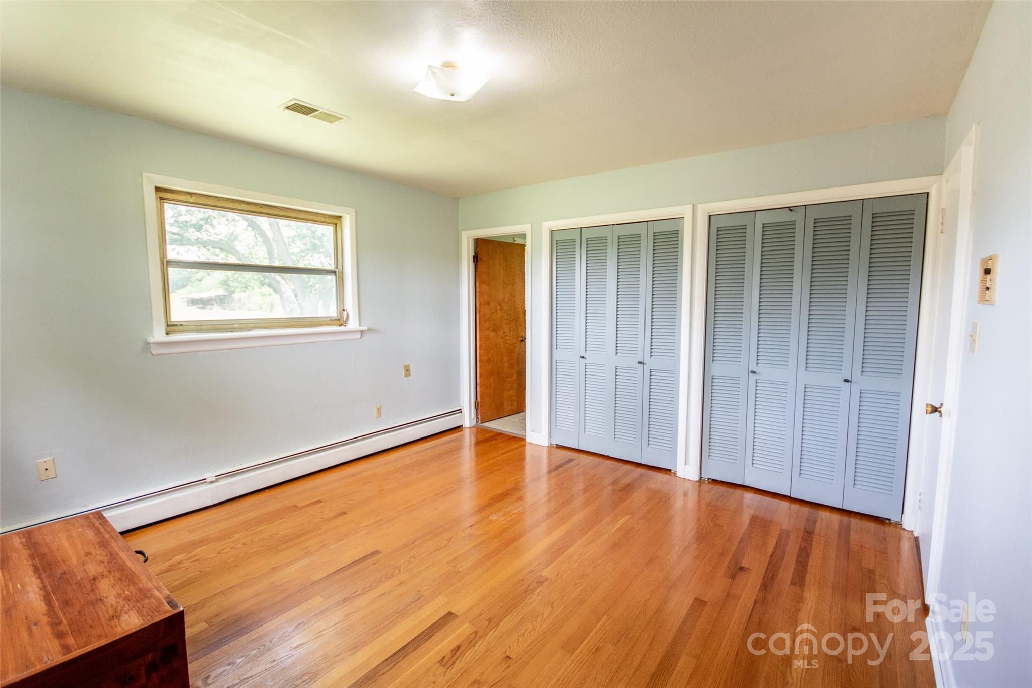 615 Bell Farm Road Statesville, NC 28625 - Photo 25 of 46 an empty room with wooden floor and windows