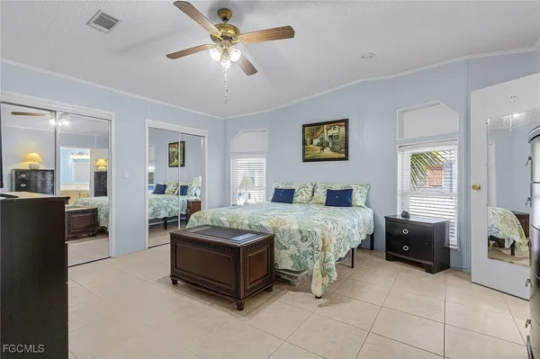 a spacious bedroom with a bed and a chandelier
