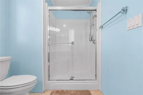 a bathroom with a shower and a toilet