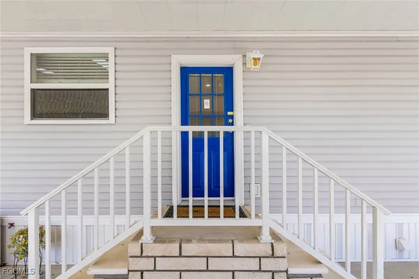 a view of front door of house with stairs
