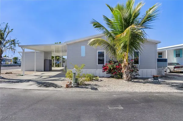 a view of a house with outdoor space and palm trees