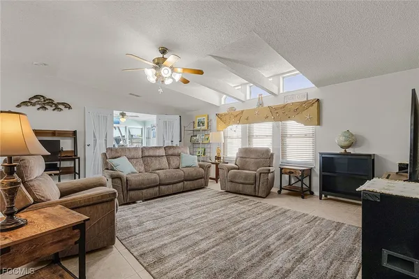 a living room with furniture fireplace and a large window
