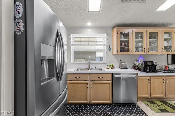 a kitchen with stainless steel appliances a stove a sink and a refrigerator