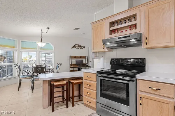 a kitchen with stainless steel appliances a stove a sink and cabinets