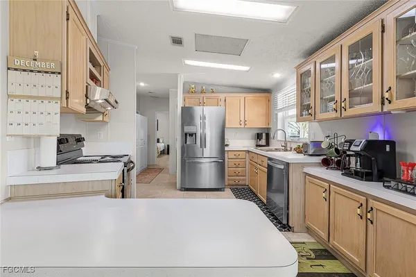 a kitchen with stainless steel appliances a refrigerator sink and cabinets