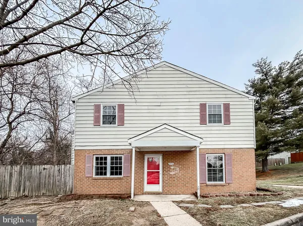 a front view of a house with a tree