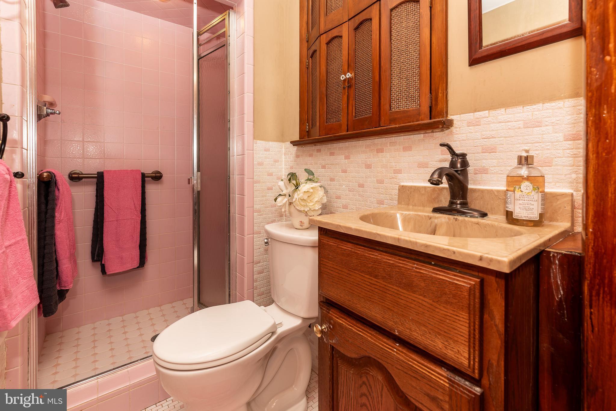 1119 Sharp Road Vineland, NJ 08360 - Photo 27 of 79 a bathroom with a sink a toilet and shower curtain