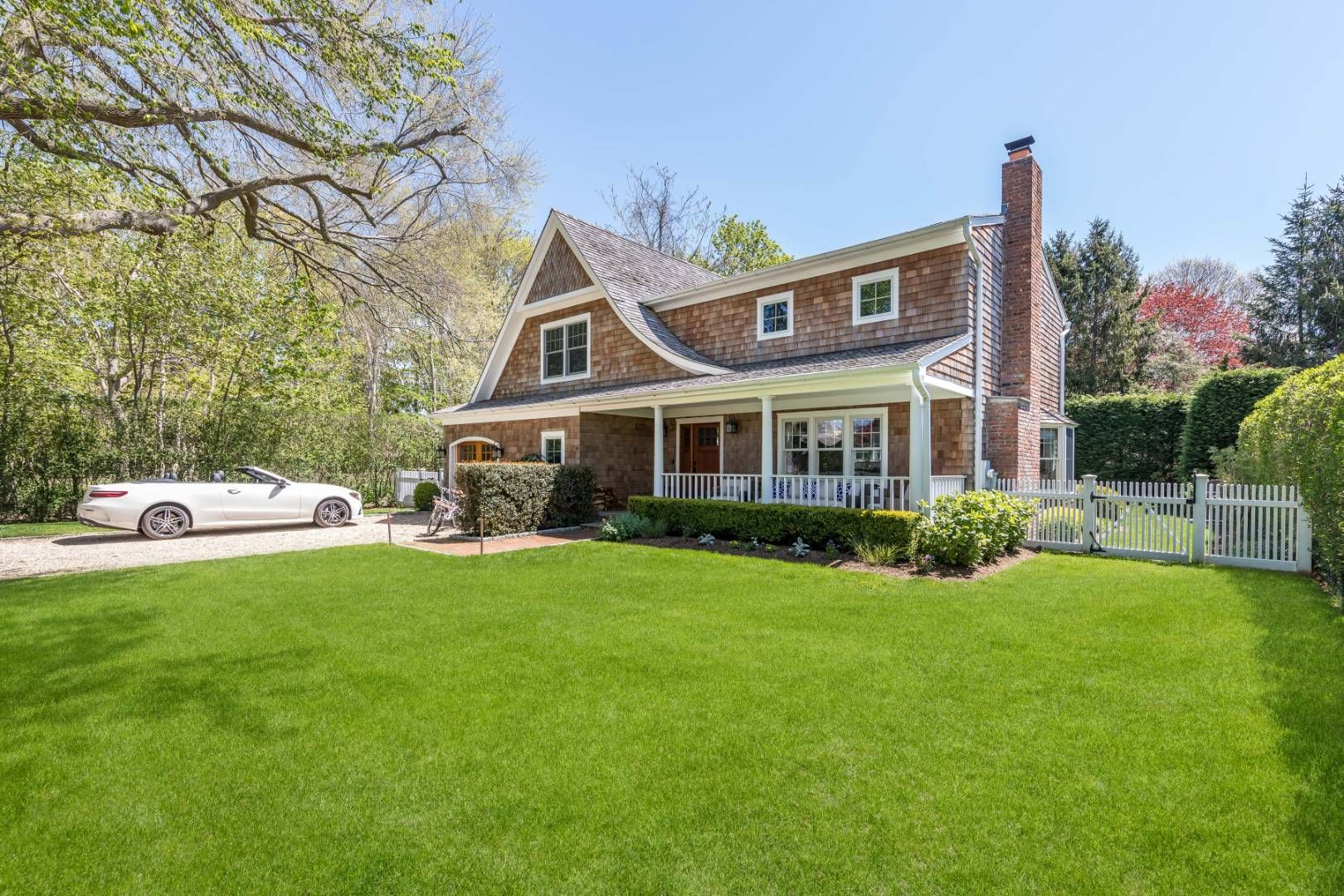 a front view of a house with a garden