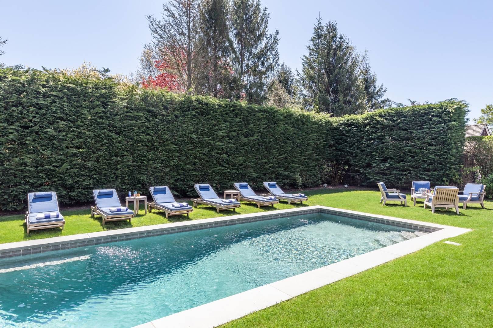 34 Sherrill Road East Hampton, NY 11937 - Photo 18 of 21 a view of a swimming pool with a yard and furniture