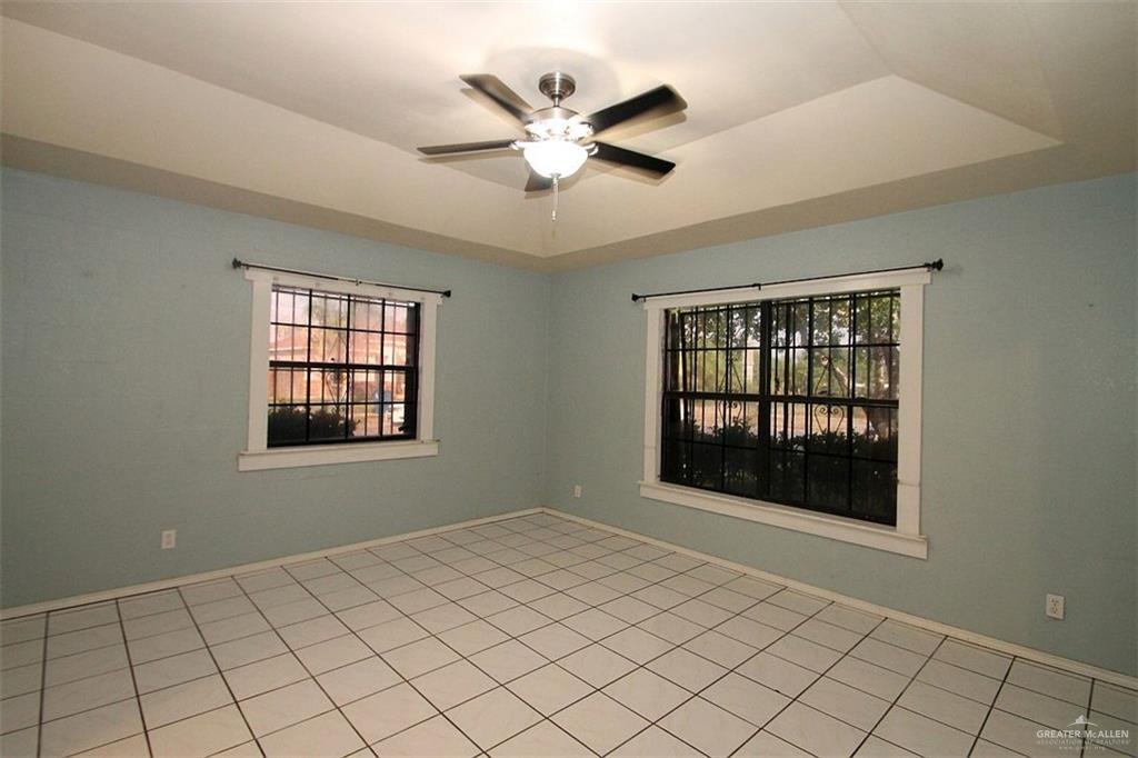 3738 Rey David Drive Brownsville, TX 78521 - Photo 2 of 12 a view of an empty room with window and chandelier fan