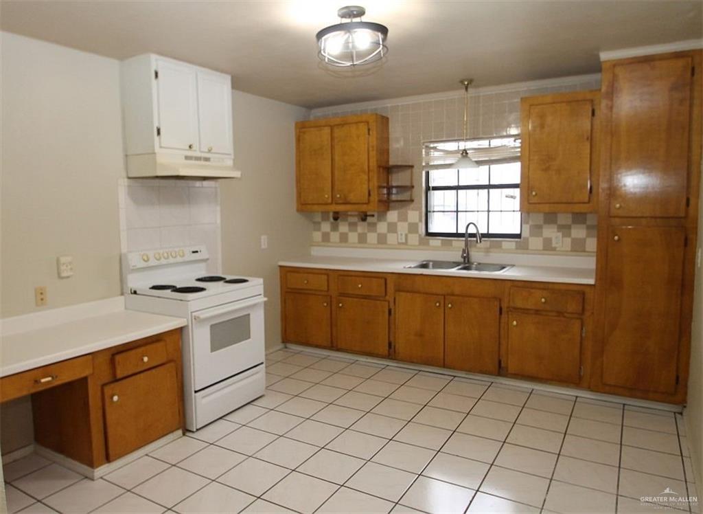 3738 Rey David Drive Brownsville, TX 78521 - Photo 3 of 12 a kitchen with a sink stove and cabinets