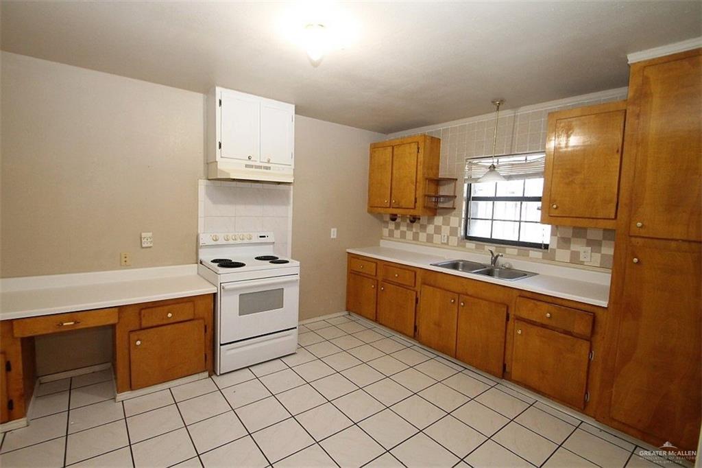 3738 Rey David Drive Brownsville, TX 78521 - Photo 4 of 12 a kitchen with stainless steel appliances granite countertop a sink and cabinets