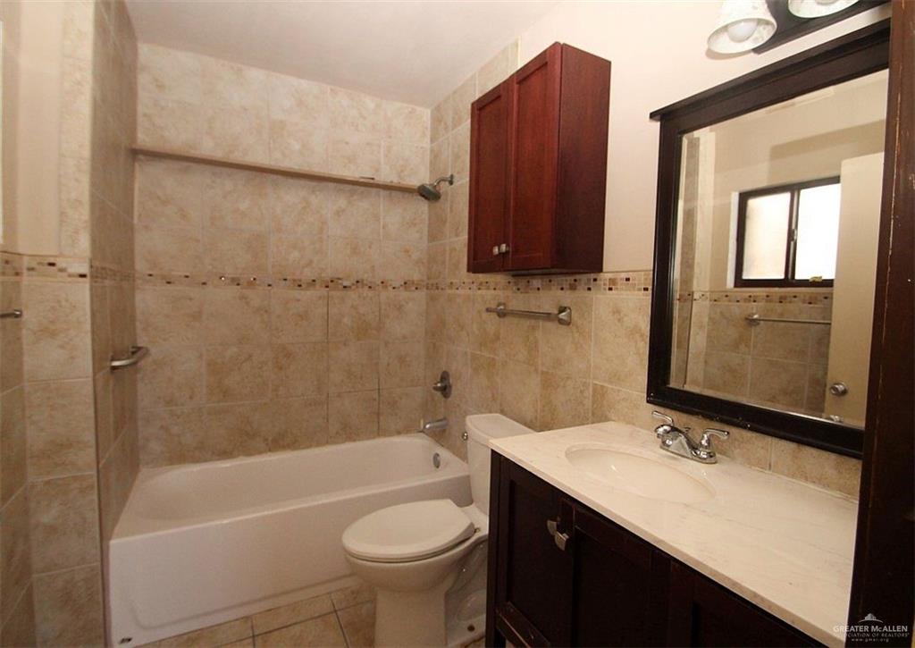 3738 Rey David Drive Brownsville, TX 78521 - Photo 6 of 12 a bathroom with a sink a toilet and bathtub