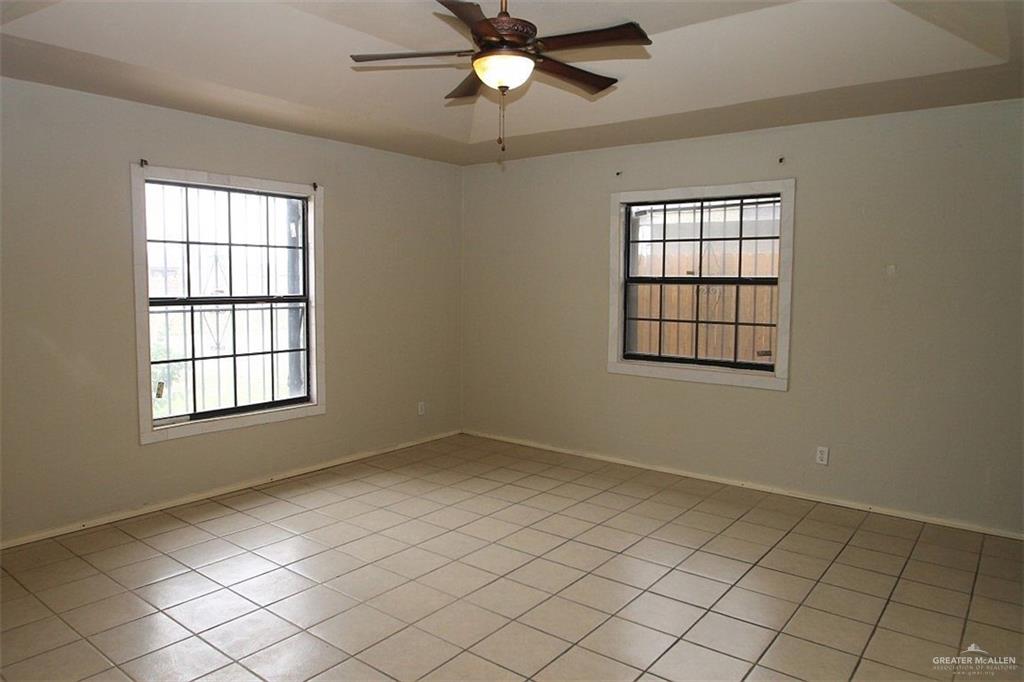3738 Rey David Drive Brownsville, TX 78521 - Photo 8 of 12 an empty room with windows and fan