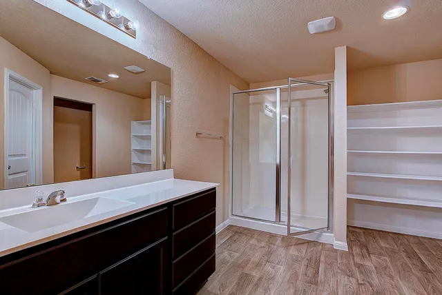a bathroom with a double vanity sink and a mirror