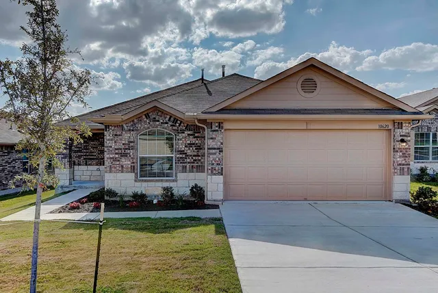 a view of a house with swimming pool and sitting area