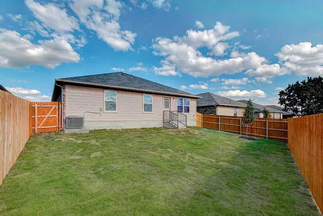 a backyard of a house with lots of green space