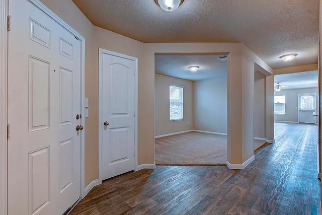 a view of hallway with wooden floor