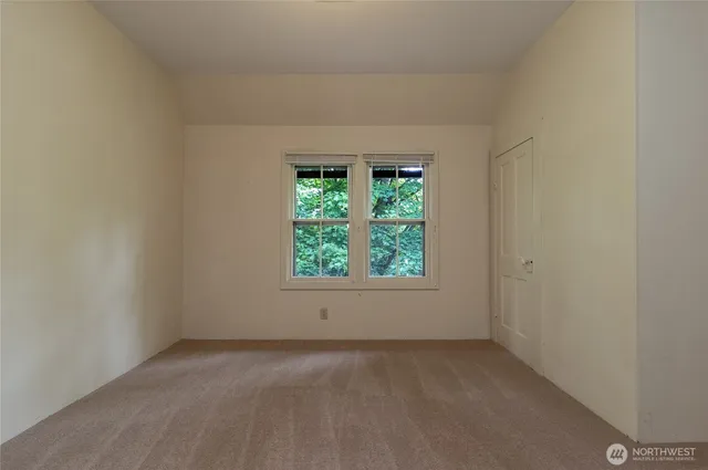 a bedroom with a large bed and a window