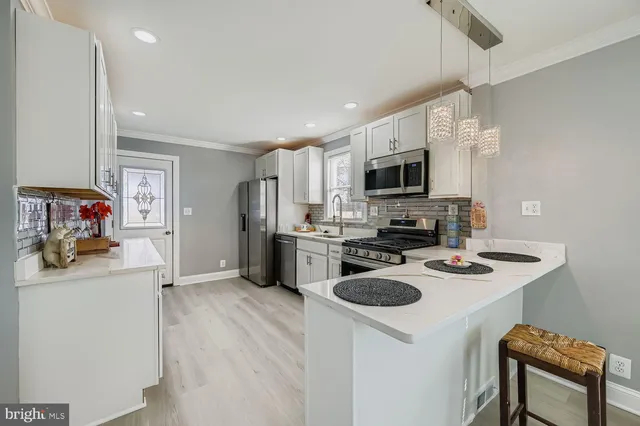 a kitchen with a sink a stove and refrigerator