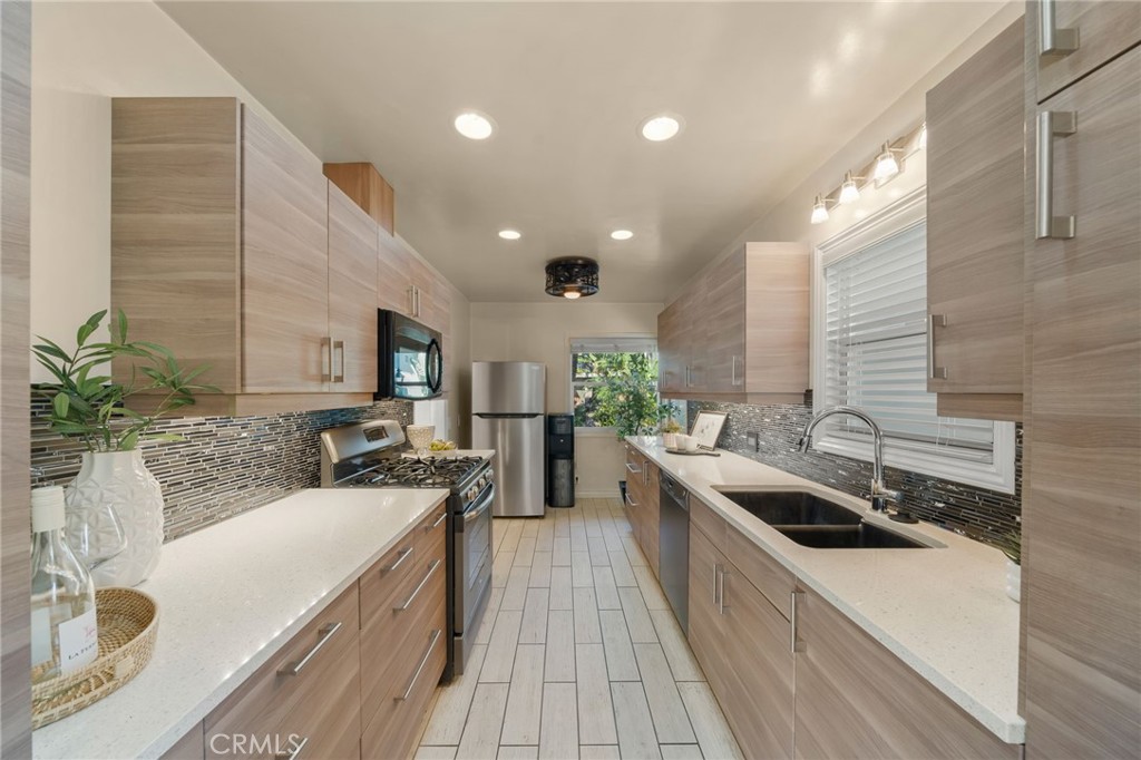 2027 East Appleton Street, Unit 1 Long Beach, CA 90803 - Photo 11 of 24 a kitchen with stainless steel appliances a sink a stove top oven a counter space and cabinets