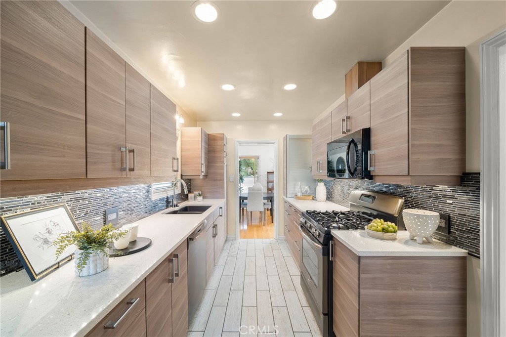 2027 East Appleton Street, Unit 1 Long Beach, CA 90803 - Photo 12 of 24 a kitchen with stainless steel appliances granite countertop a stove a sink and a microwave