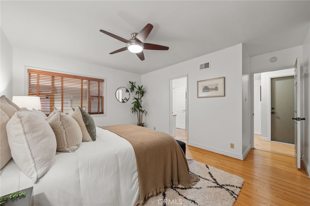 2027 East Appleton Street, Unit 1 Long Beach, CA 90803 - Photo 7 of 24 a bedroom with a large bed and wooden floor