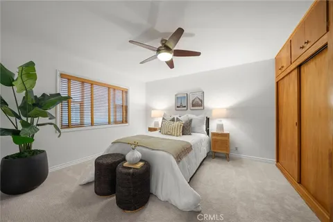 a living room with a bed furniture and a potted plant