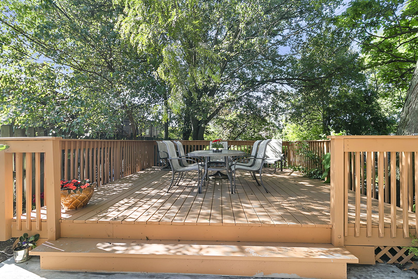 421 Herrick Road Riverside, IL 60546 - Photo 25 of 41 a view of a patio with table and chairs with wooden fence and floor