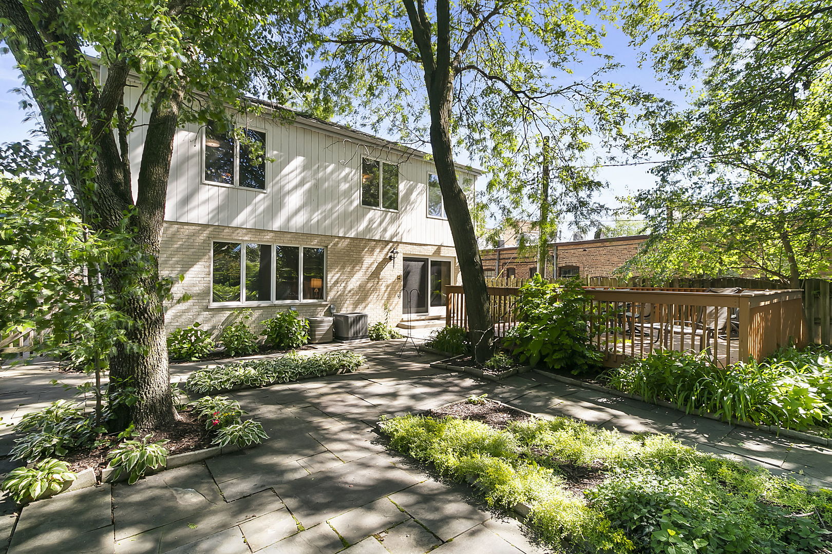 421 Herrick Road Riverside, IL 60546 - Photo 28 of 41 a view of a brick house with a yard and plants